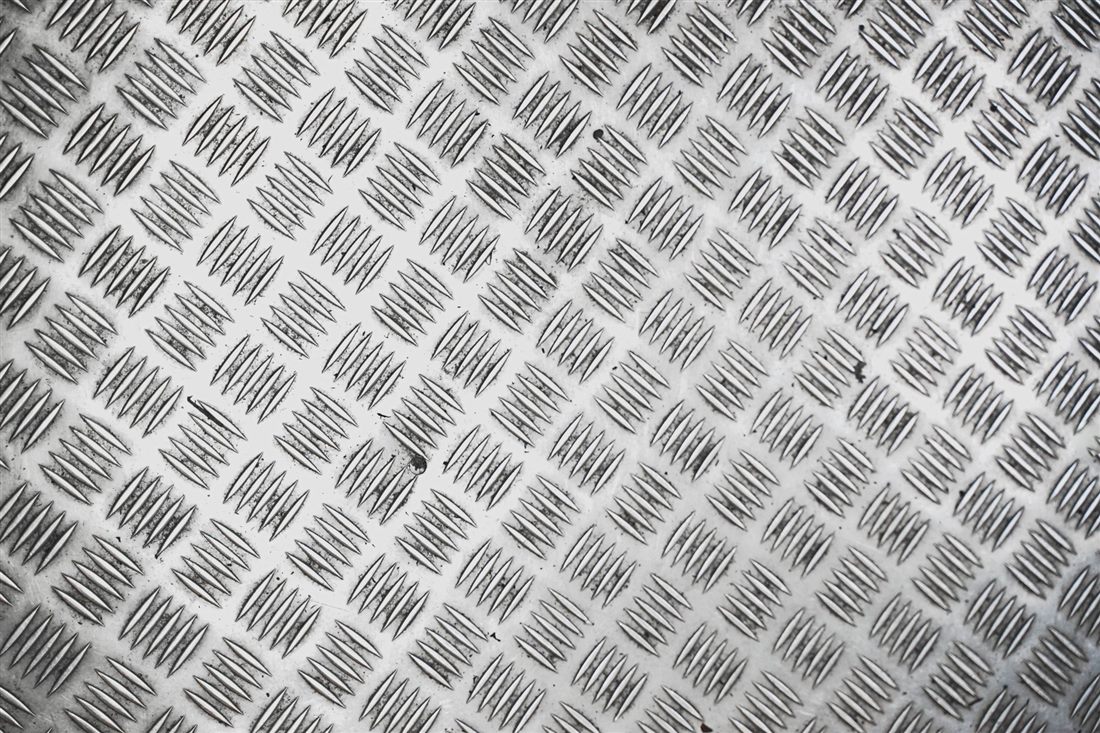 Close-up of checkered stainless steel surface texture