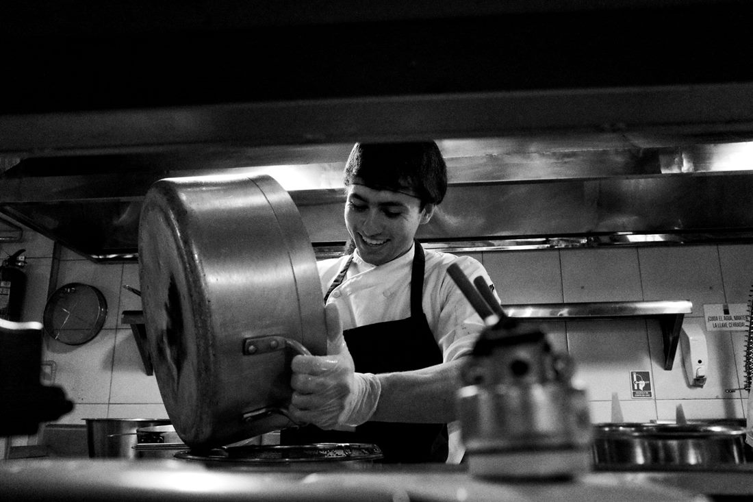 Chef working quickly in a busy commercial kitchen