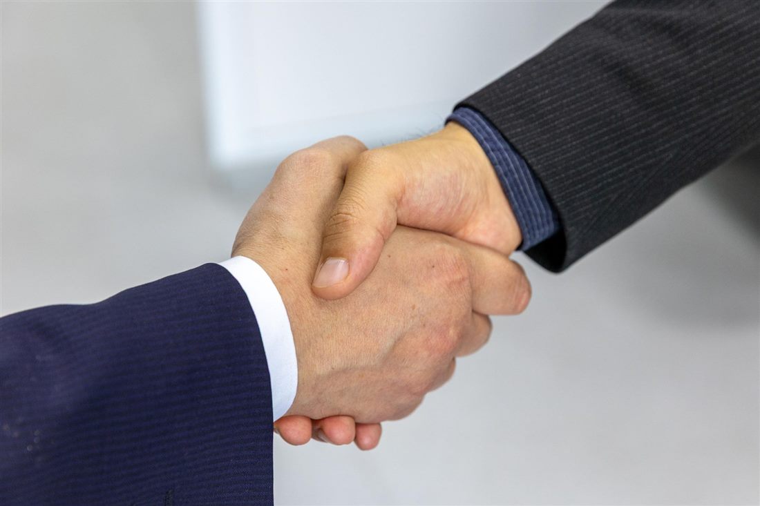 Two business partners shaking hands on a supply agreement