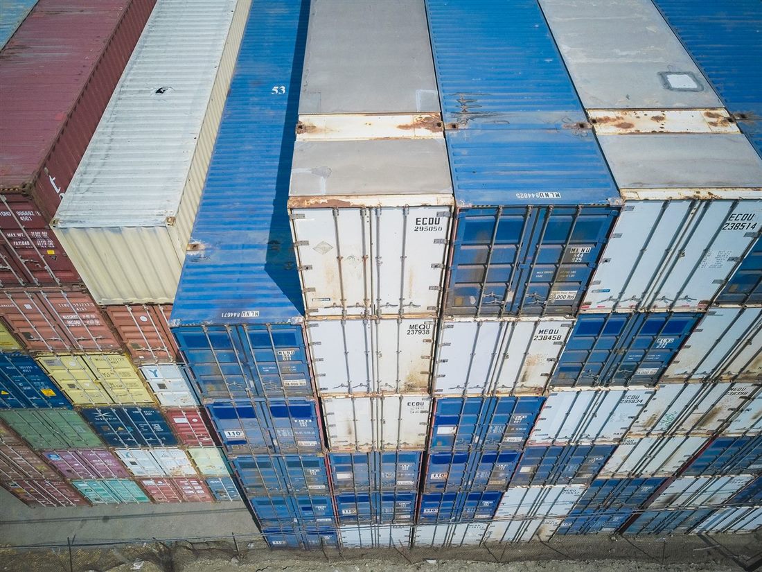 Aerial view of stacked shipping containers at a logistics yard